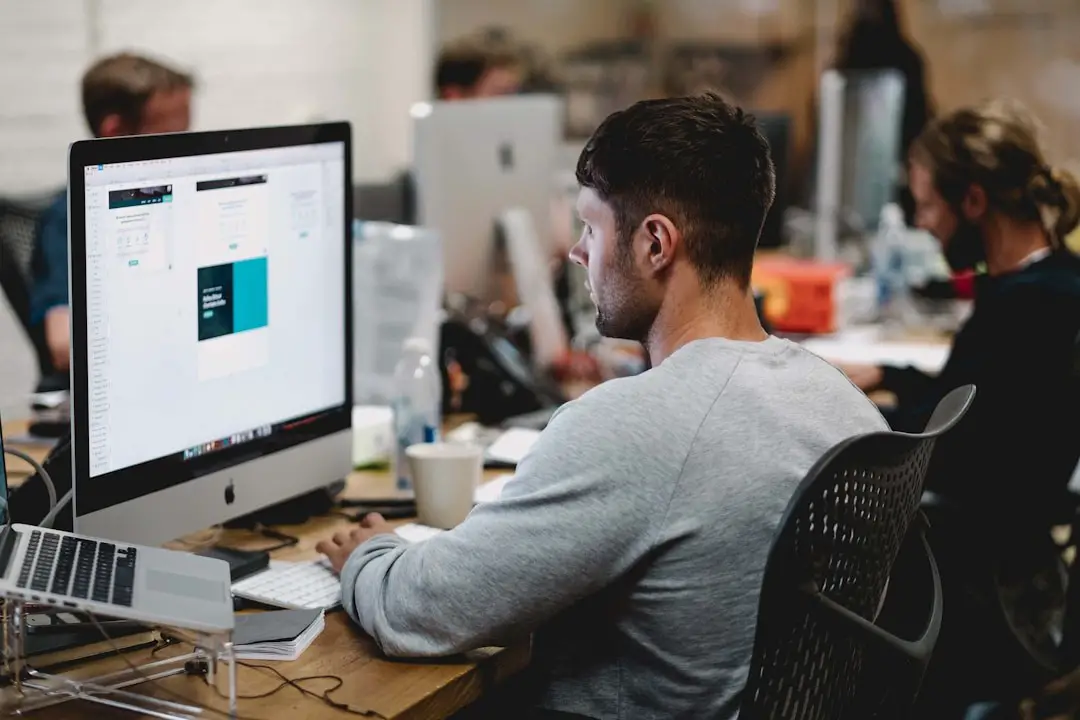 A man in an office researching sales enablement on his computer