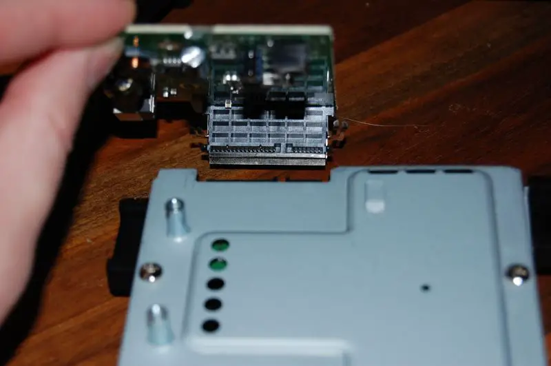 Slide the circuit board upwards (away from the drive), just like you did for the metal casing.